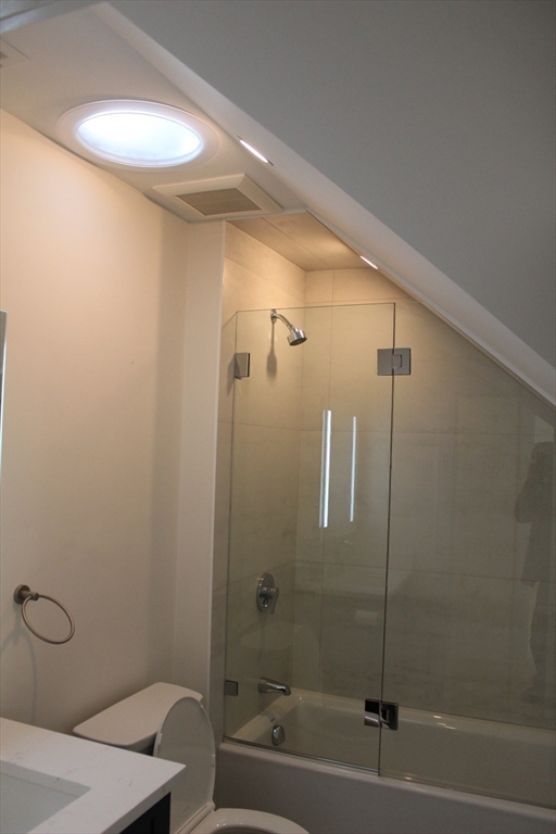 71 Mozart Street, Unit 3 Boston, MA 02130 - Photo 16 of 26 a bathroom with a shower and a bath tub