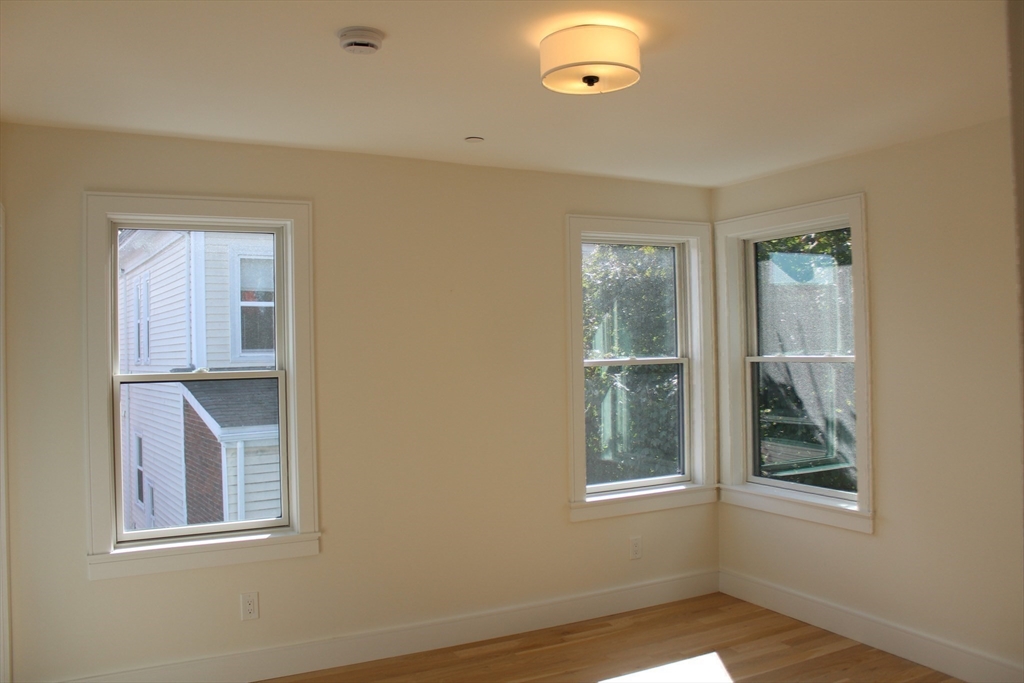 71 Mozart Street, Unit 3 Boston, MA 02130 - Photo 19 of 26 an empty room with windows