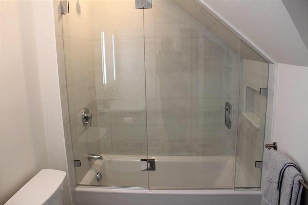 71 Mozart Street, Unit 3 Boston, MA 02130 - Photo 21 of 26 a bathroom with a tub and a shower