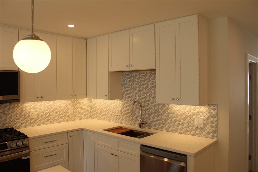 71 Mozart Street, Unit 3 Boston, MA 02130 - Photo 8 of 26 a kitchen with a sink and cabinets