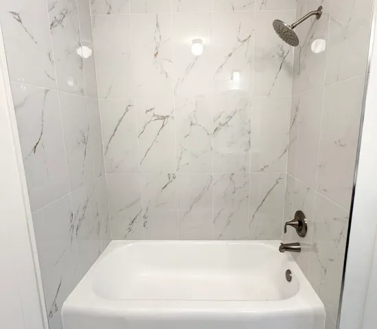 a bathroom with a white bath tub
