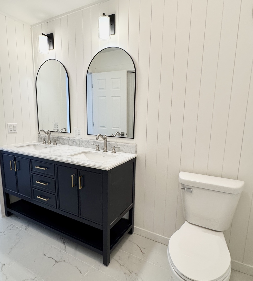 633 Dulles Road, Unit A Des Plaines, IL 60016 - Photo 15 of 26 a bathroom with a double vanity sink toilet and a mirror