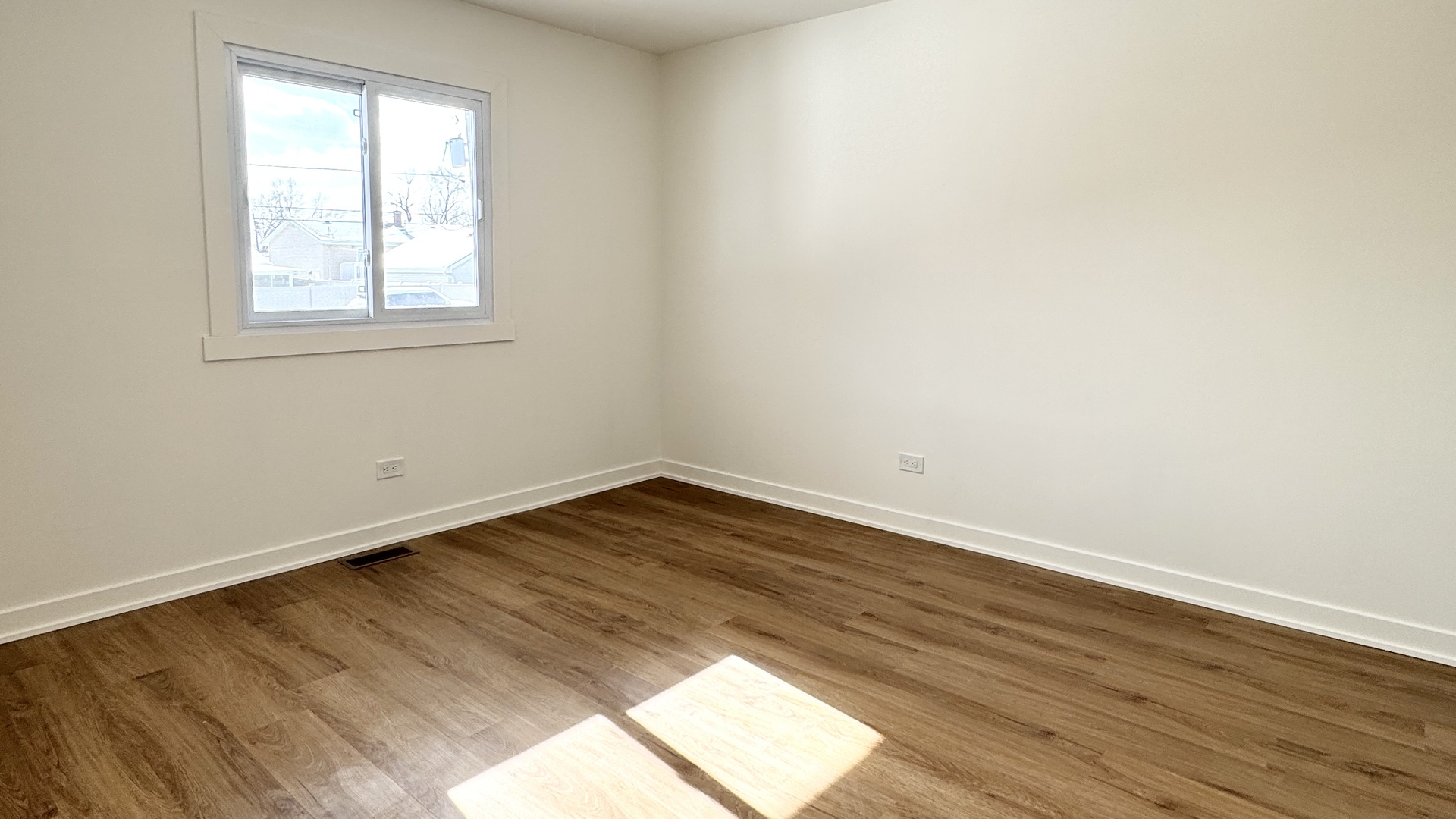633 Dulles Road, Unit A Des Plaines, IL 60016 - Photo 19 of 26 an empty room with wooden floor and windows
