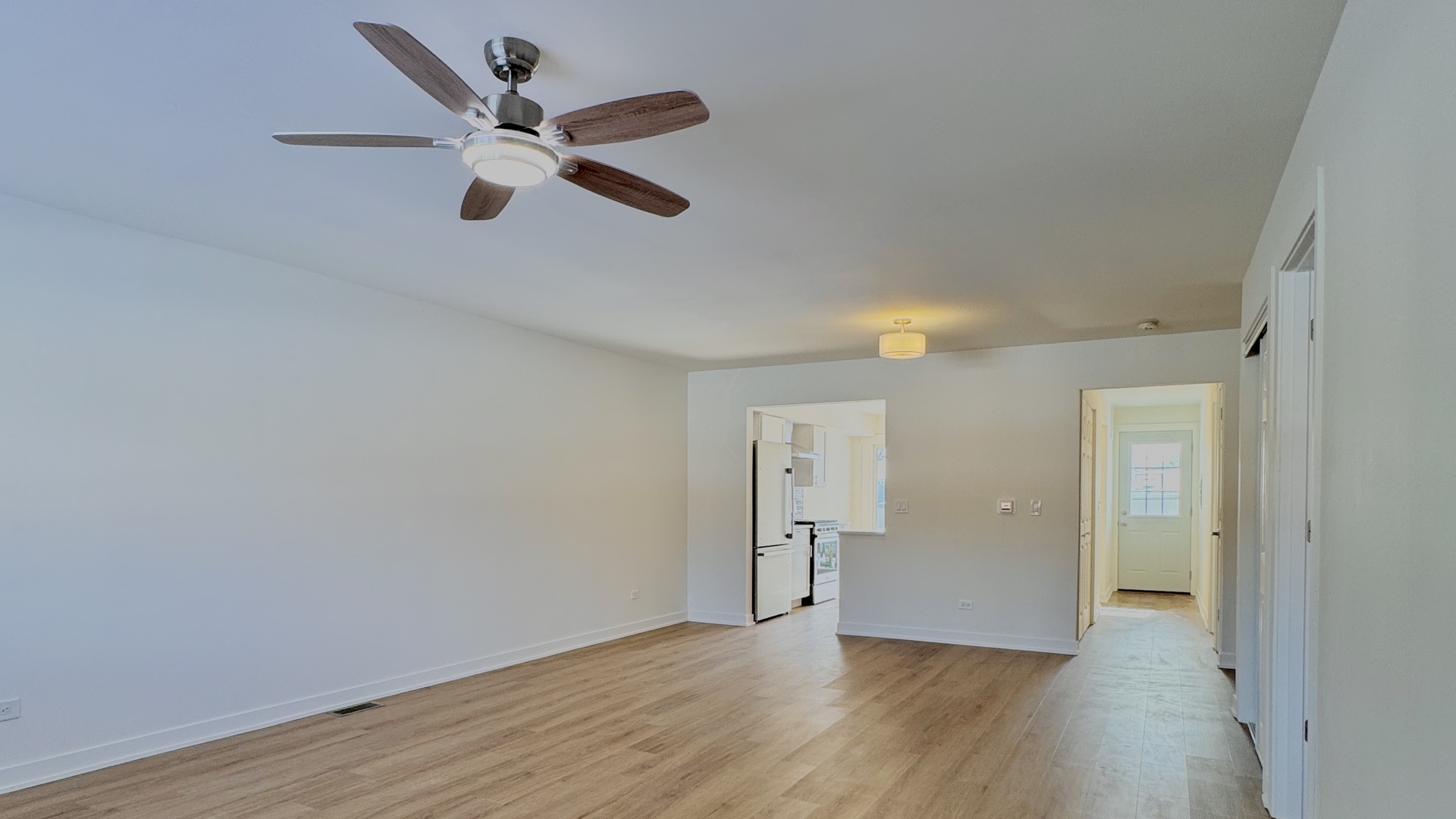 633 Dulles Road, Unit A Des Plaines, IL 60016 - Photo 2 of 26 wooden floor in an empty room with a ceiling fan