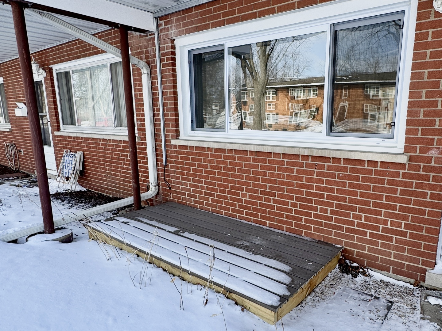 633 Dulles Road, Unit A Des Plaines, IL 60016 - Photo 24 of 26 a view of a bench in front of house