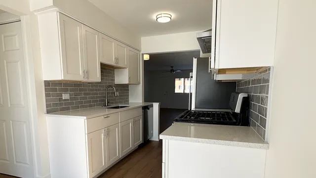 a kitchen that has a sink and a stove