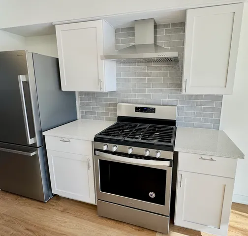 a stove top oven sitting inside of a kitchen