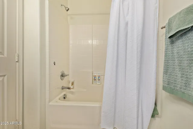 a living room with furniture a flat screen tv and a window