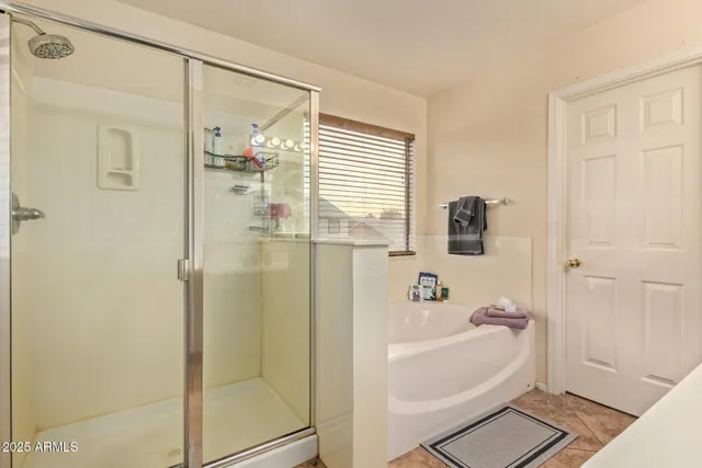 an empty room with closet and a ceiling fan