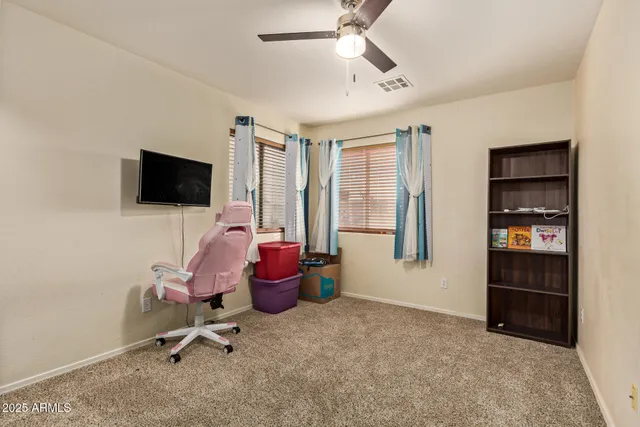 a bedroom with a bed and a tv