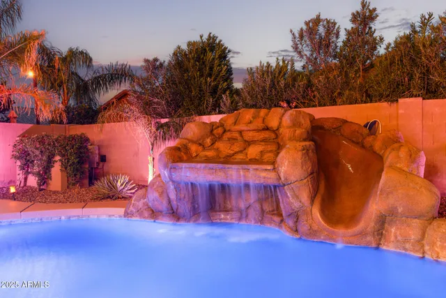 an outdoor space with pool and furniture