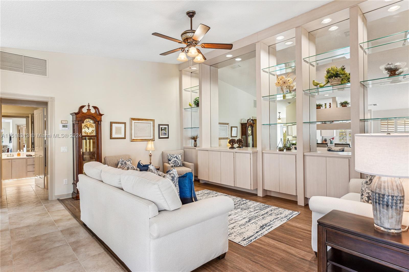 256 Brier Circle Jupiter, FL 33458 - Photo 11 of 50 a living room with furniture and a chandelier