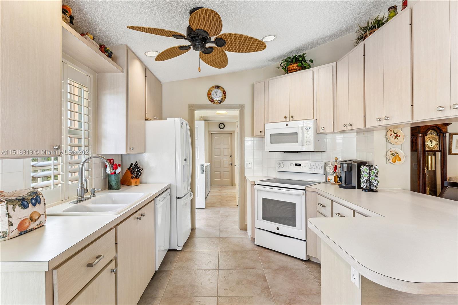 256 Brier Circle Jupiter, FL 33458 - Photo 14 of 50 a kitchen with stainless steel appliances a stove a sink and a refrigerator