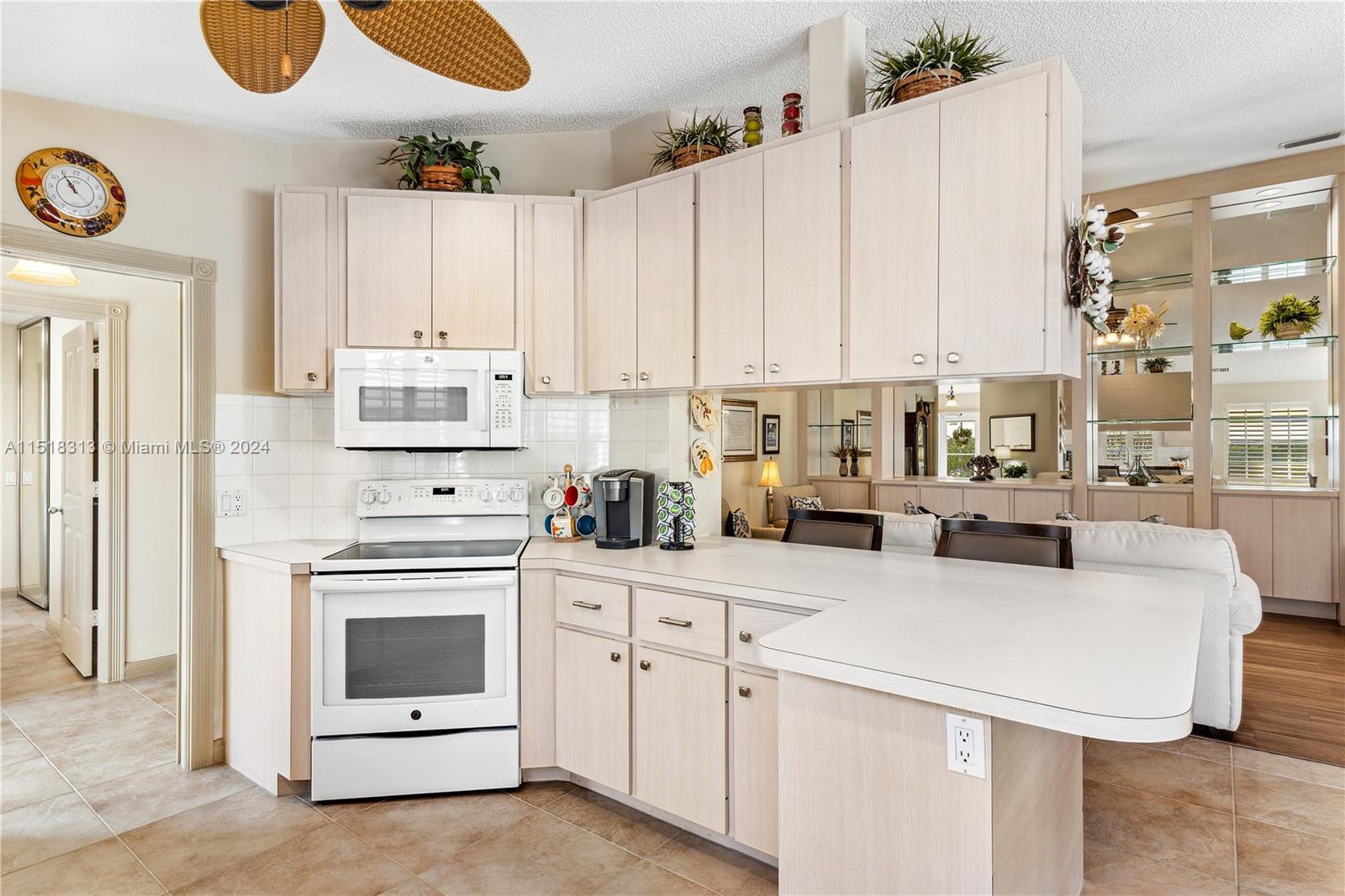 256 Brier Circle Jupiter, FL 33458 - Photo 15 of 50 a kitchen with a white cabinets and appliances