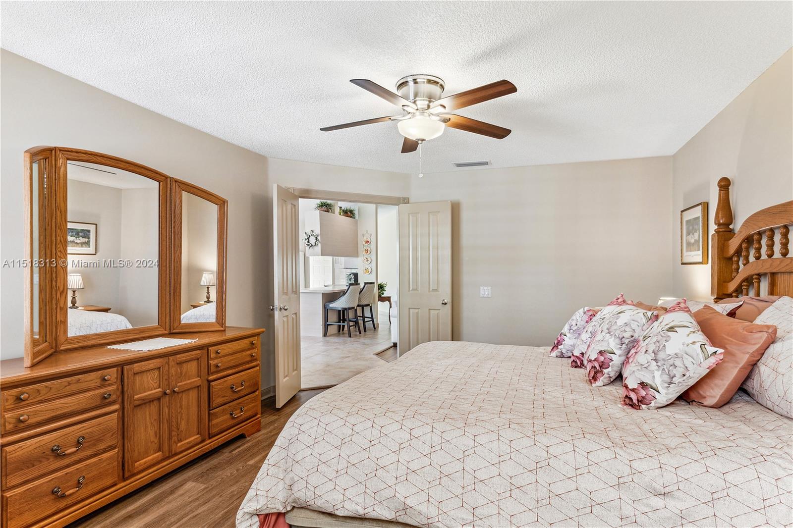 256 Brier Circle Jupiter, FL 33458 - Photo 23 of 50 a bedroom with a bed and a large mirror on dresser