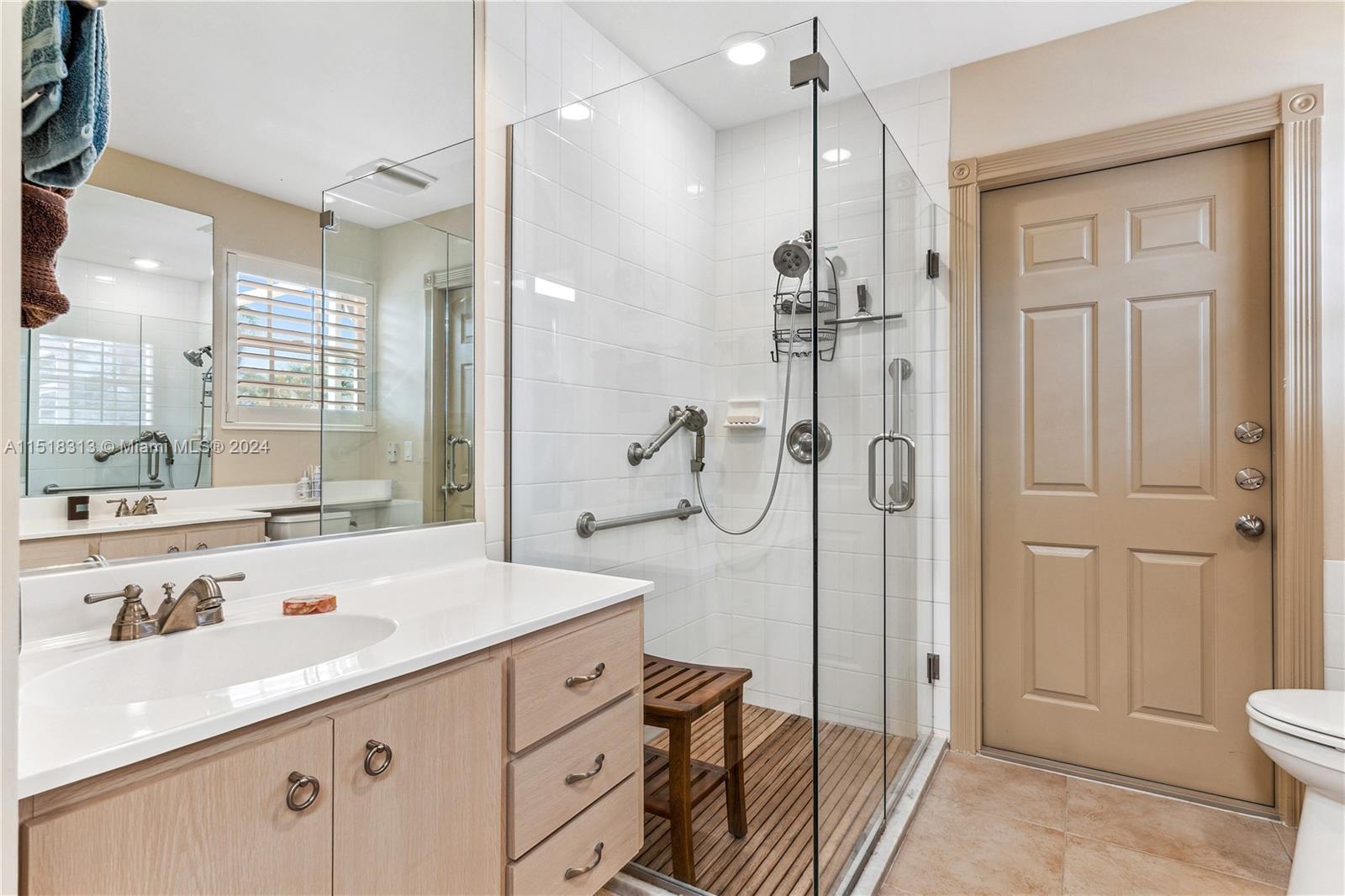 256 Brier Circle Jupiter, FL 33458 - Photo 25 of 50 a bathroom with a granite countertop sink a toilet and shower