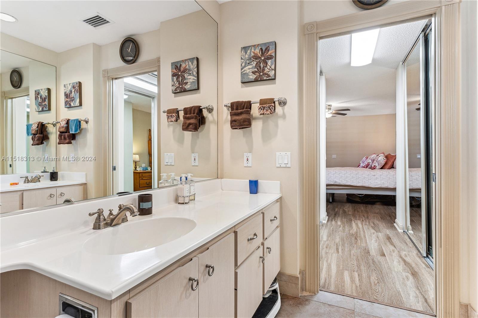 256 Brier Circle Jupiter, FL 33458 - Photo 26 of 50 a en suite bathroom with a sink a mirror and a shower