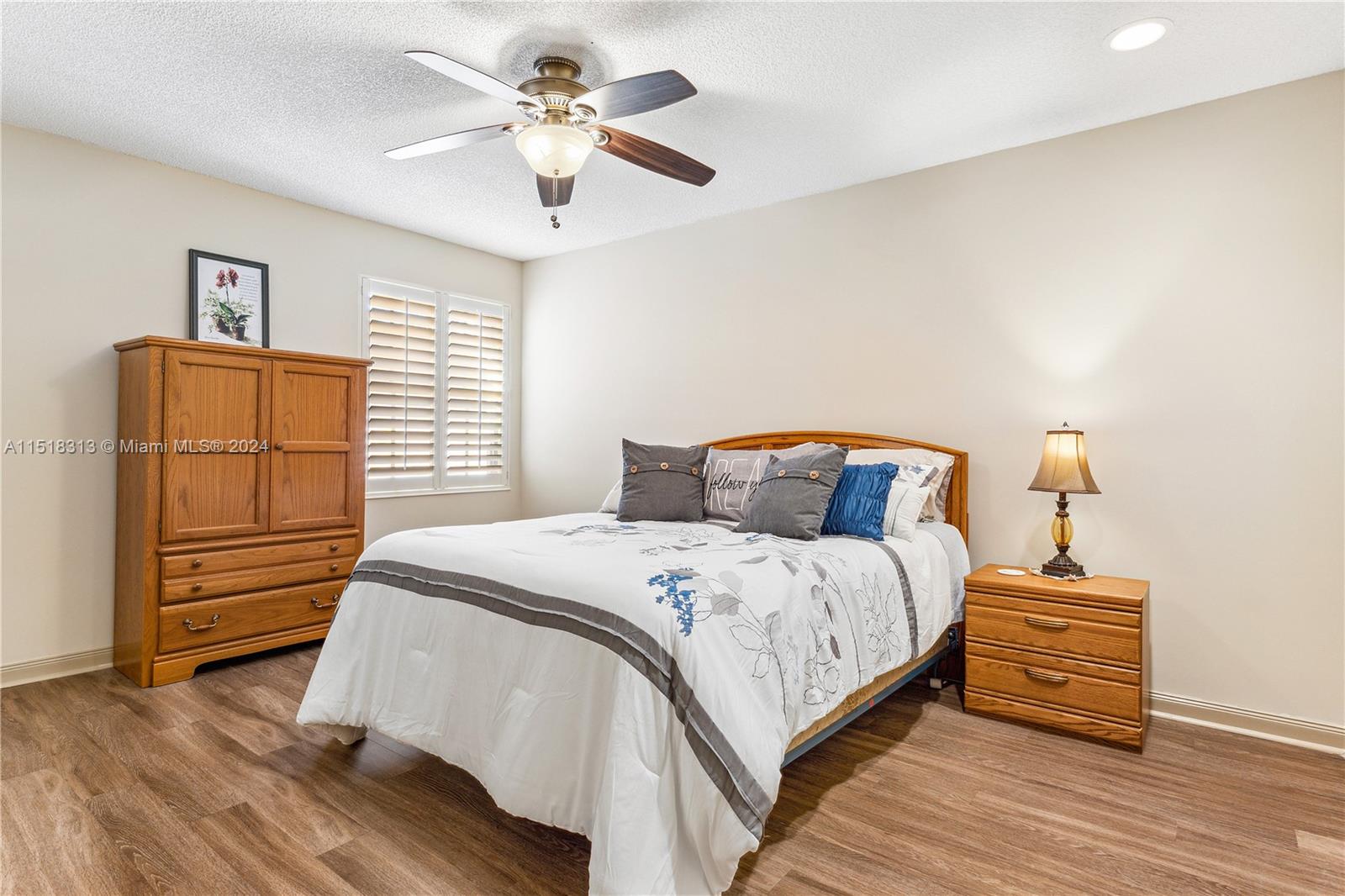 256 Brier Circle Jupiter, FL 33458 - Photo 27 of 50 a bedroom with a bed and a chandelier