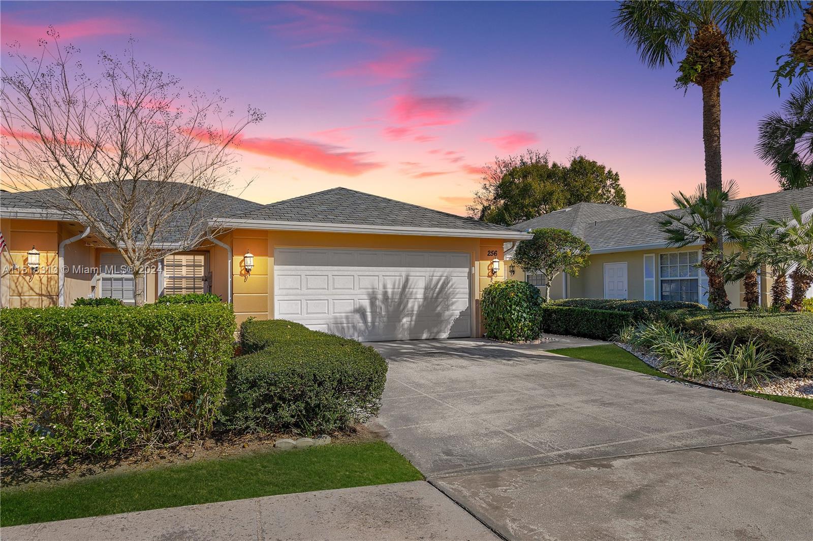 256 Brier Circle Jupiter, FL 33458 - Photo 3 of 50 a front view of a house with a yard and garage