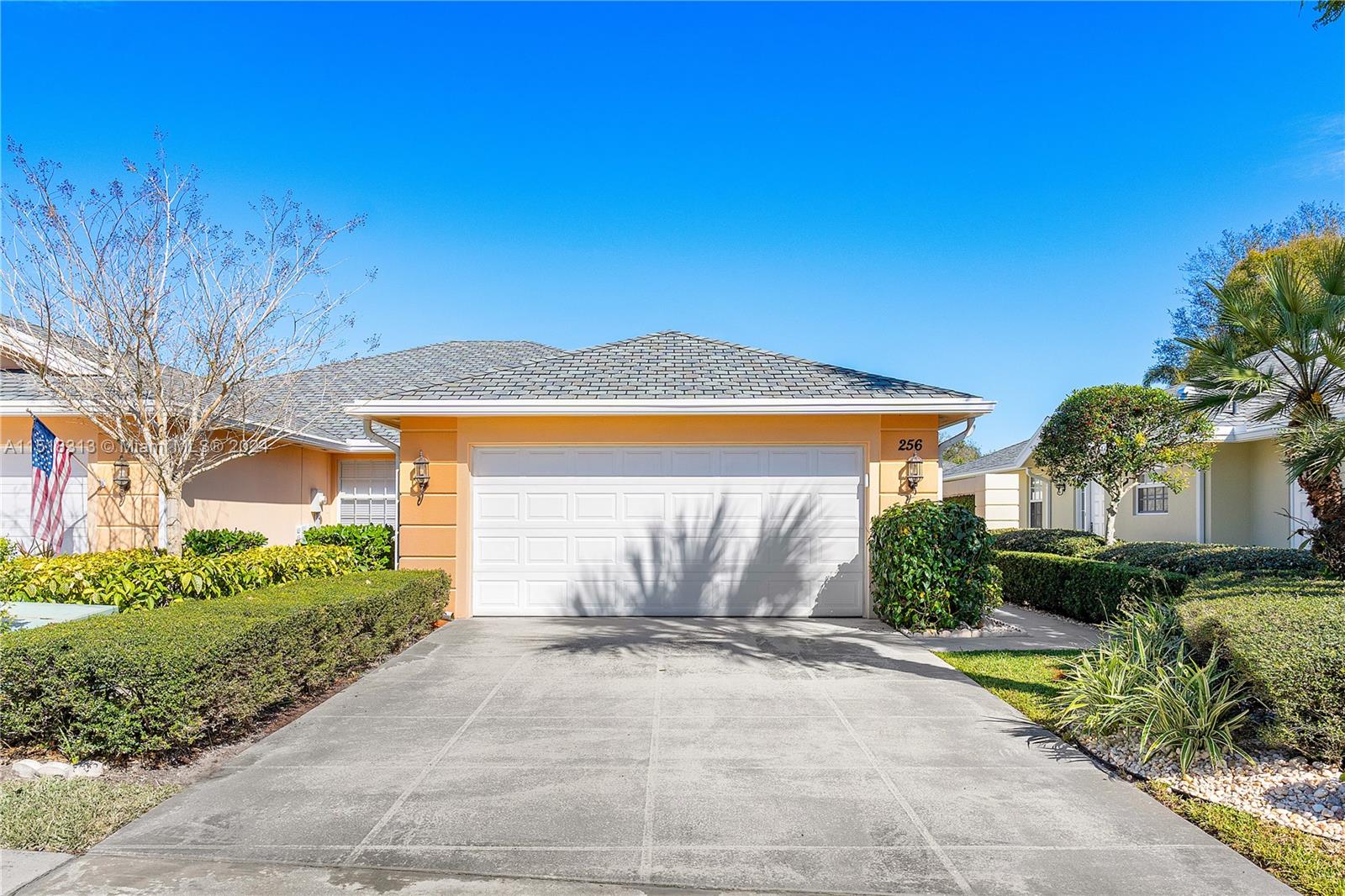 256 Brier Circle Jupiter, FL 33458 - Photo 37 of 50 a front view of a house with a yard and garage