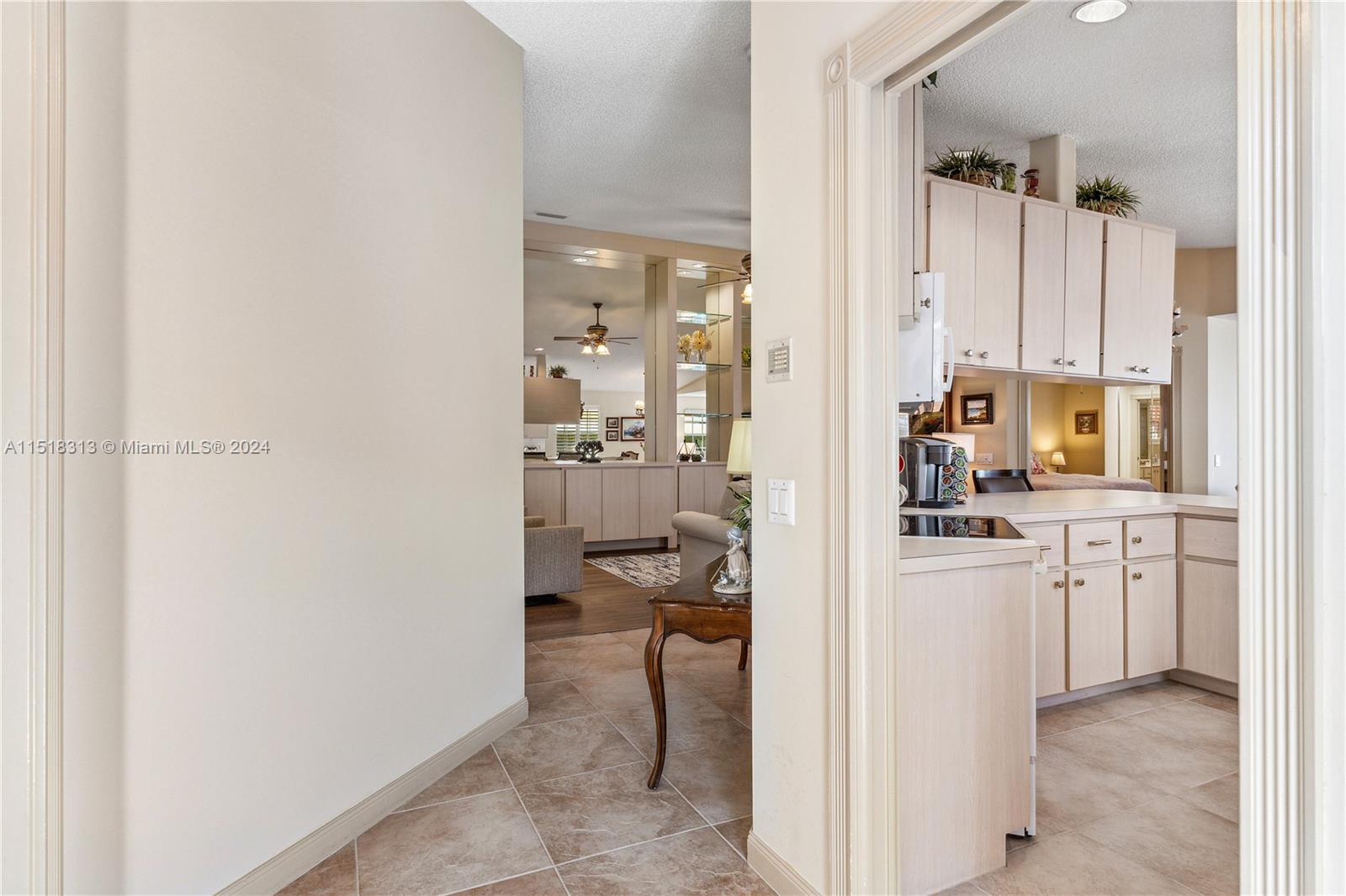 256 Brier Circle Jupiter, FL 33458 - Photo 8 of 50 a view of a kitchen with a sink and dishwasher with white cabinets