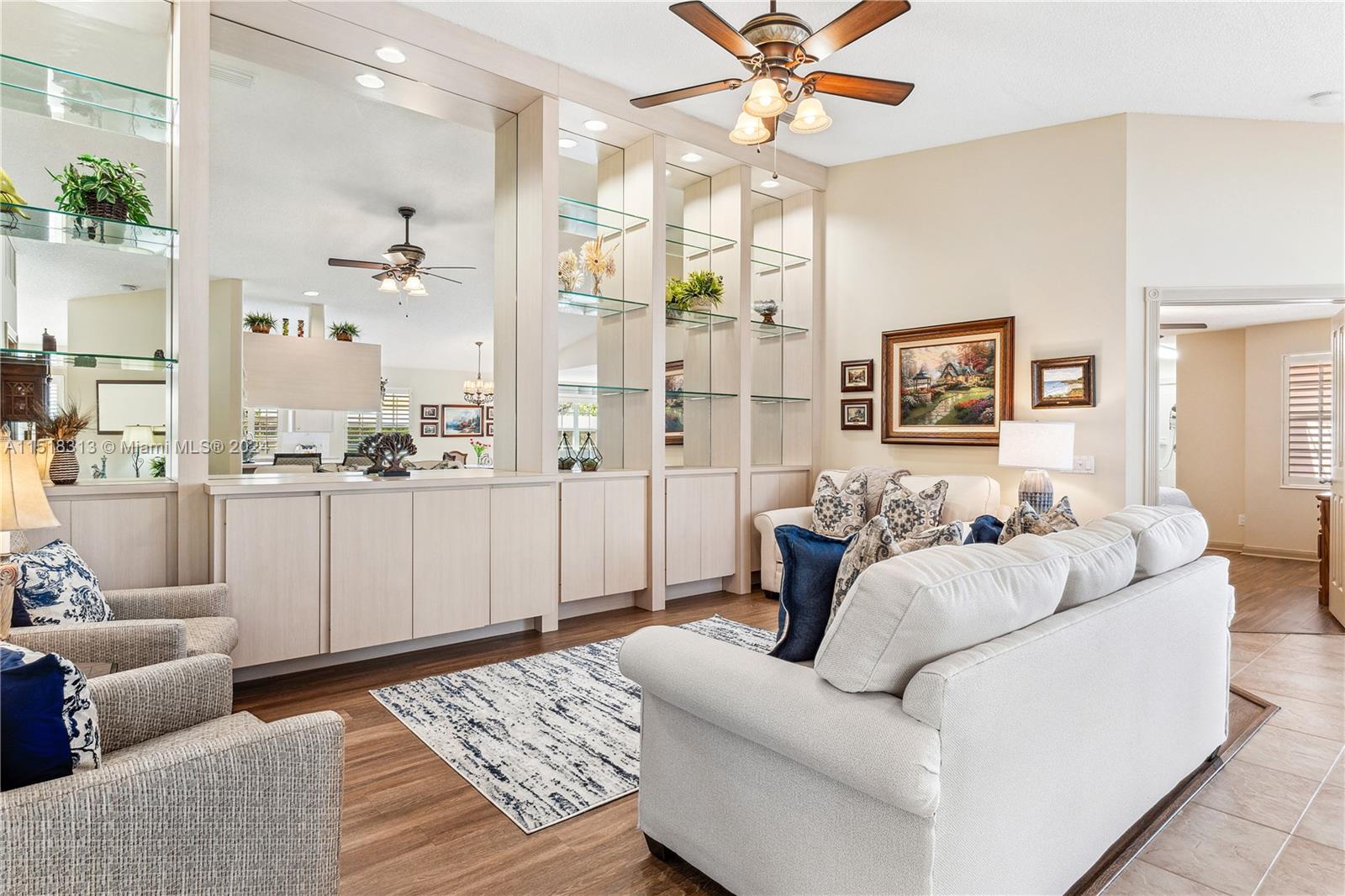 256 Brier Circle Jupiter, FL 33458 - Photo 10 of 50 a living room with furniture and a chandelier