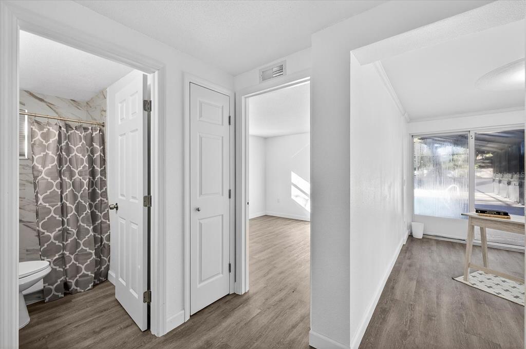 4928 Amherst Court New Port Richey, FL 34652 - Photo 12 of 50 a view of a hallway with wooden floor and a bathroom
