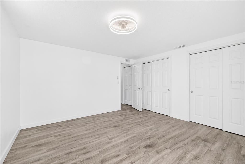 4928 Amherst Court New Port Richey, FL 34652 - Photo 15 of 50 a view of an empty room with wooden floor