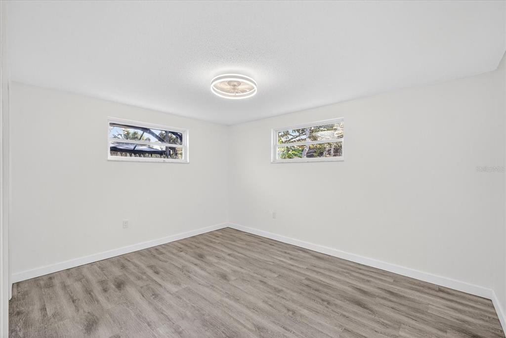 4928 Amherst Court New Port Richey, FL 34652 - Photo 17 of 50 an empty room with a bench