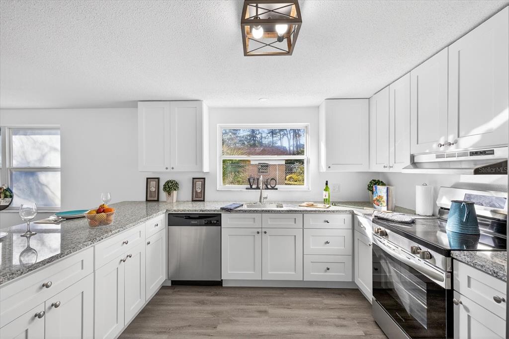 4928 Amherst Court New Port Richey, FL 34652 - Photo 28 of 50 a kitchen with cabinets and window