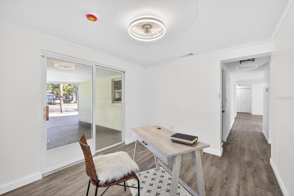 4928 Amherst Court New Port Richey, FL 34652 - Photo 30 of 50 a view of a hallway with wooden floor and furniture