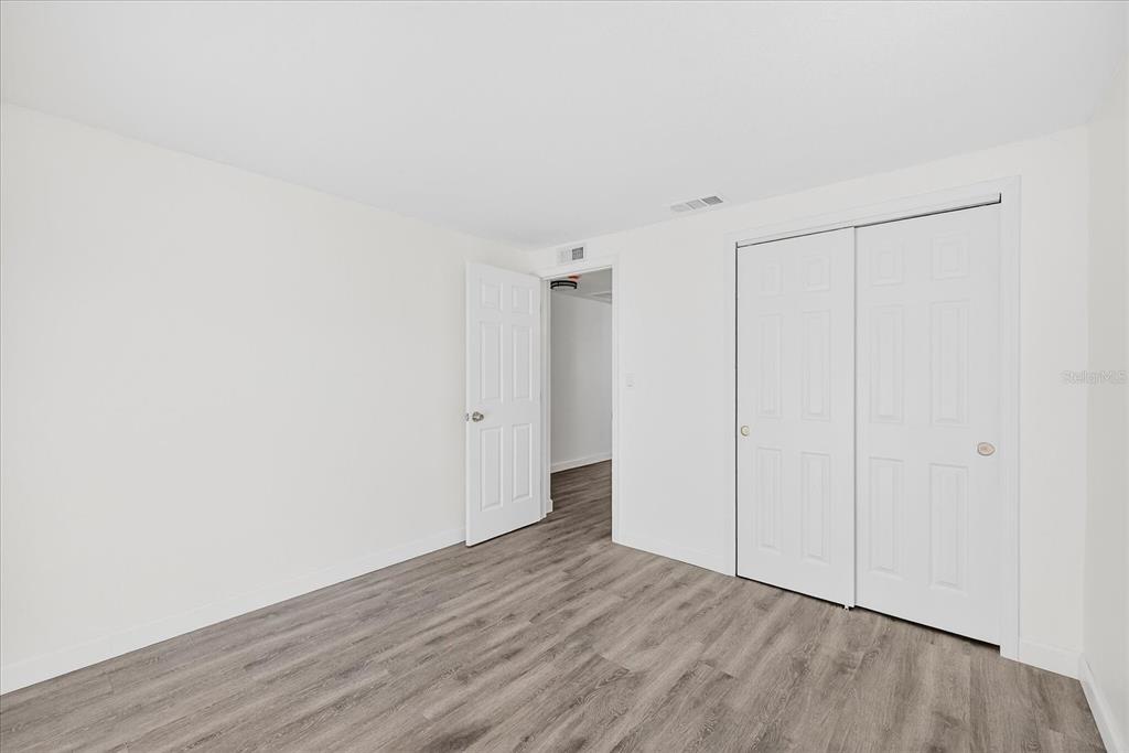 4928 Amherst Court New Port Richey, FL 34652 - Photo 38 of 50 a view of an empty room with wooden floor