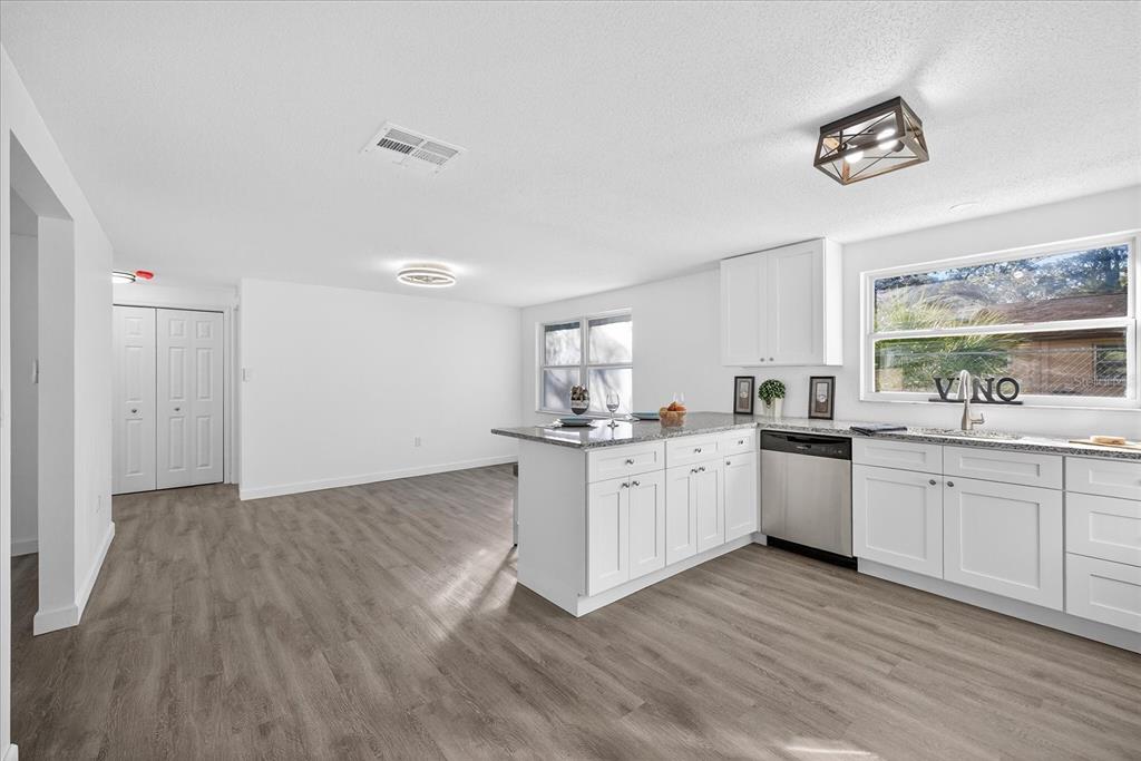 4928 Amherst Court New Port Richey, FL 34652 - Photo 39 of 50 a kitchen with granite countertop a sink cabinets and wooden floor