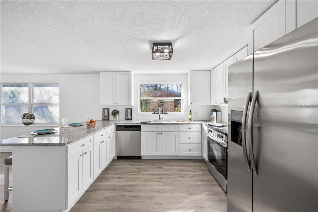 4928 Amherst Court New Port Richey, FL 34652 - Photo 4 of 50 a kitchen with a sink stove and refrigerator