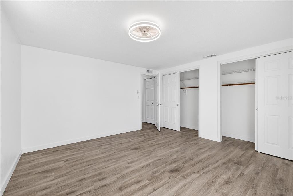 4928 Amherst Court New Port Richey, FL 34652 - Photo 43 of 50 a view of an empty room with wooden floor