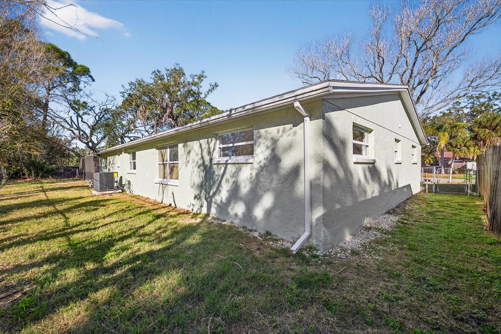 4928 Amherst Court New Port Richey, FL 34652 - Photo 49 of 50 a view of backyard with a garden and trees