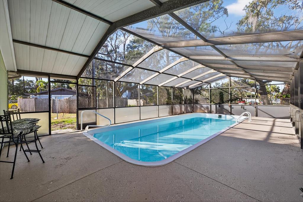 4928 Amherst Court New Port Richey, FL 34652 - Photo 6 of 50 a view of a swimming pool with a patio