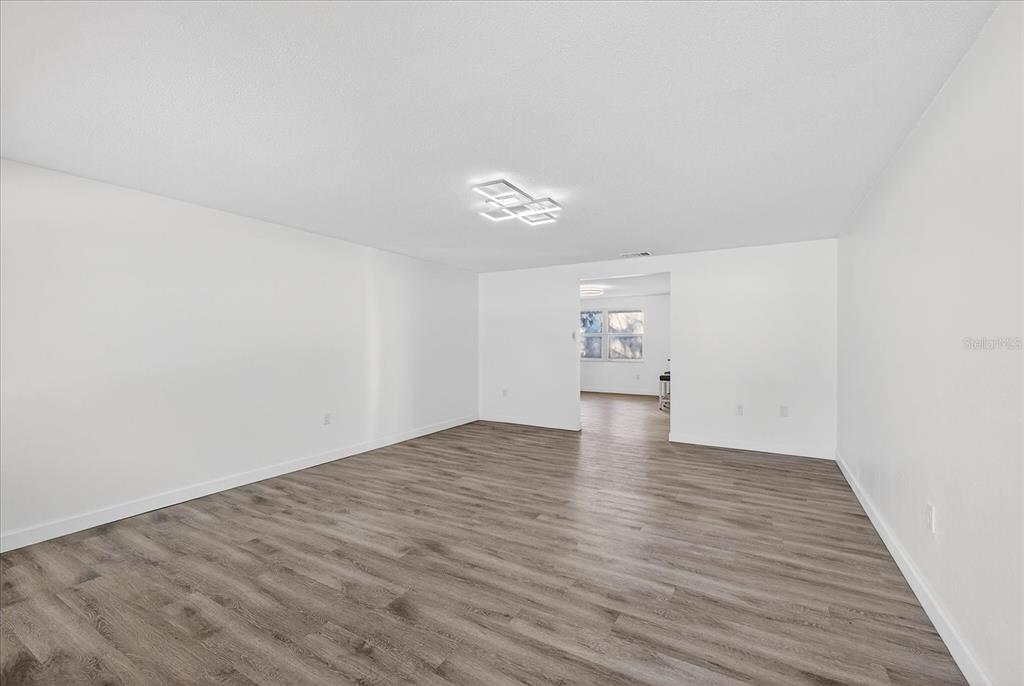 4928 Amherst Court New Port Richey, FL 34652 - Photo 8 of 50 a view of an empty room and wooden floor