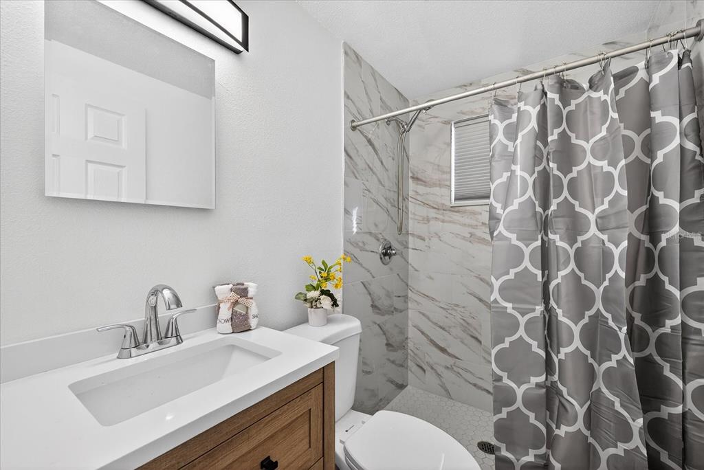 4928 Amherst Court New Port Richey, FL 34652 - Photo 10 of 50 a bathroom with a sink toilet and shower