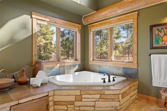 a bath tub sitting in a bathroom next to a window
