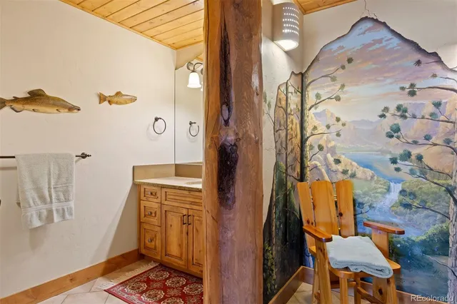 a bathroom with a sink and mirror with toilet