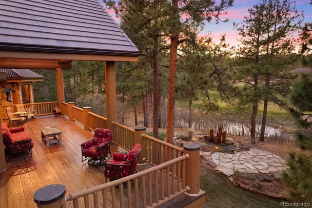 a view of a patio with table and chairs and wooden floor