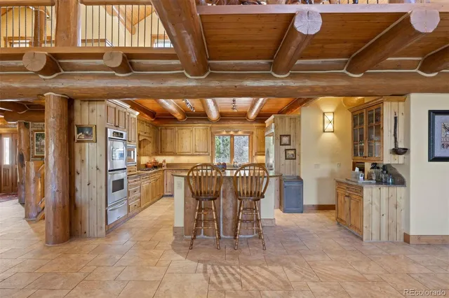 a dining room with furniture and a kitchen view