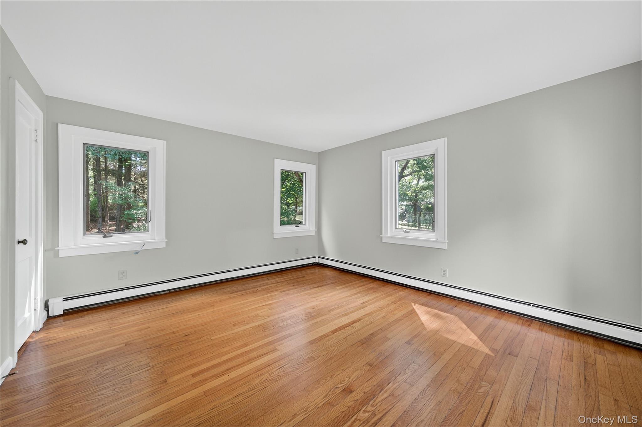 91 Sleepy Valley Road Warwick, NY 10990 - Photo 18 of 30 a view of an empty room with wooden floor and a window