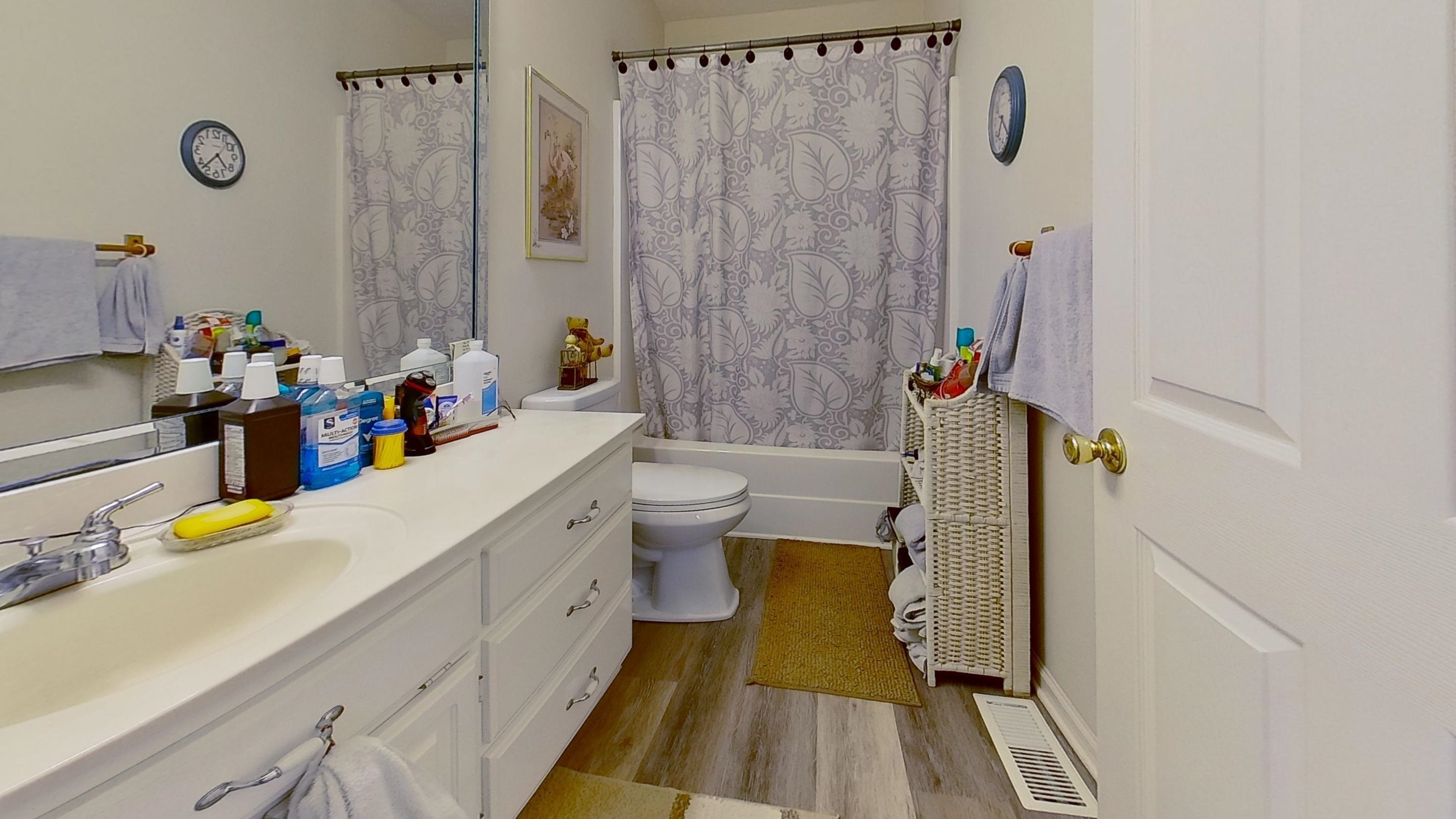 30 Rodeo Way Savannah, TN 38372 - Photo 15 of 29 Bathroom with shower / bath combination with curtain, vanity, and light wood-style flooring