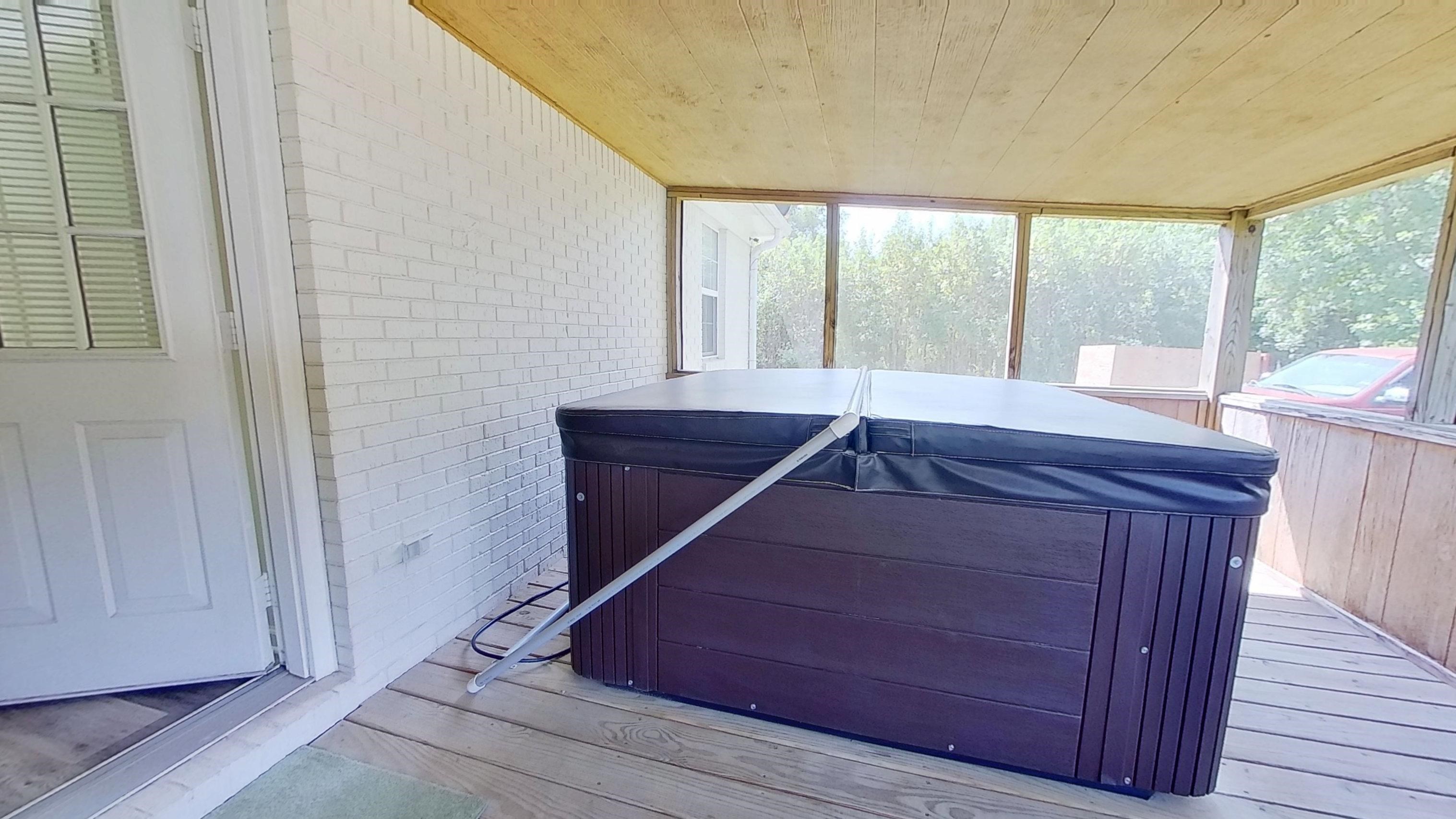 30 Rodeo Way Savannah, TN 38372 - Photo 20 of 29 Wooden terrace with a hot tub and a sunroom