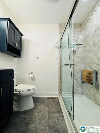 a bathroom with a toilet a sink and shower