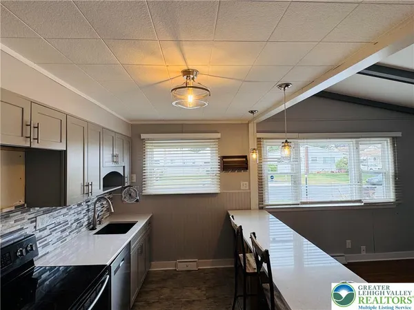 a kitchen with a counter space a sink and appliances