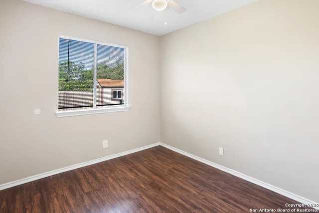 a view of a room with wooden floor