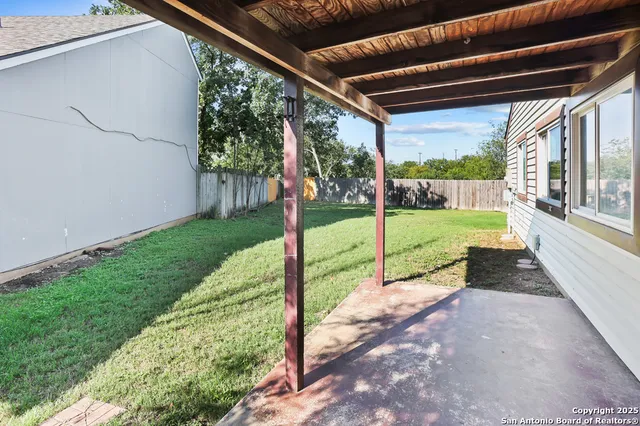 a view of a house with a backyard